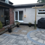 back garden with stones and concrete pavement